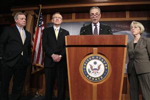 New York Sen. Charles Schumer (at the podium) has accused the Republican of holding up budget talks over issues that have more to do with culture wars than cost savings.